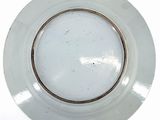 a white plate with a gold rim on a white table