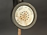 a close up of an old sewing machine with a button