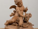 statue of a child with a bird and a dog on a table