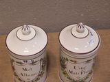 two canisters that are sitting on a table