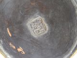 a close up of a metal bowl with a design on it
