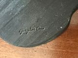 a close up of a black shoe on a wooden table