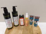 many different types of skin care products on a wooden board