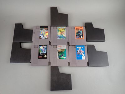 six cartouches de jeux Nintendo disposées en forme de croix