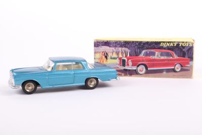 toy car and box of disney cars on a white surface