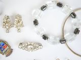 a lot of jewelry that is laying out on the table