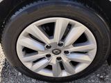 a close up of a car ' s tire on a gravel road