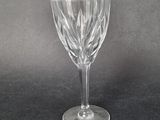 an empty wine glass sitting on top of a black table
