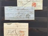many old envelopes on display in a glass case