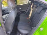 a green car with black seats in the back of it