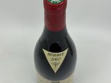 the bottle of wine is sitting on the table ready to be eaten