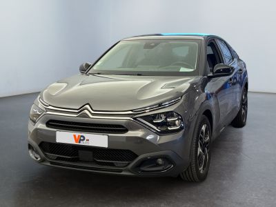 the front of a grey citrole parked in a large room