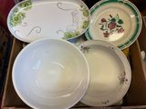 several plates and bowls are sitting in a box on a table