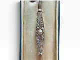 an image of a diamond and pearl bracelet in a box