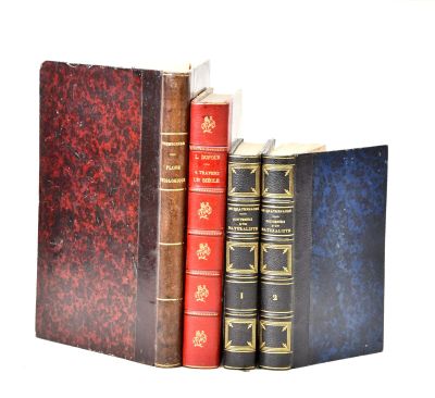 three books sitting next to each other on a white surface