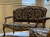 three chairs and a table in a room