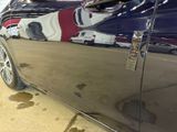 a close up of a car ' s paint job on the side of the car
