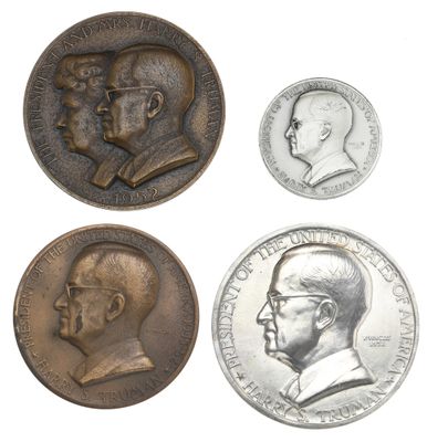 four different types of commemorative coins are shown on a white surface