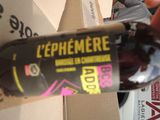 a person holding a bottle of wine in front of a box