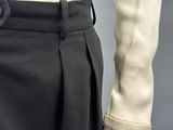 a close up of a person wearing a black pants and a white shirt