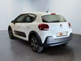 the rear end of a white citrole parked in a room