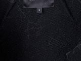 a close up of a black jacket with a label on it