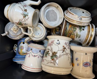 many cups and mugs that are sitting on a shelf