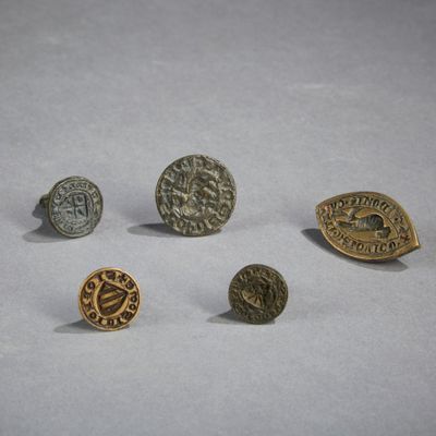 four different types of metal buttons on a white surface