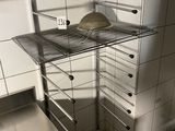an image of a kitchen with a pizza on a shelf