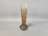 a glass vase that has a brown and white design on it