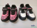 three pairs of pink and black running shoes on a white surface