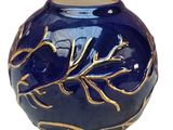 a blue vase with a gold leaf design on it