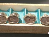 three silver cuff watches are in a box with a blue tray