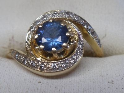 an image of a ring with a blue stone in it