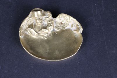 silver plated figurine of a man and a woman holding a baby