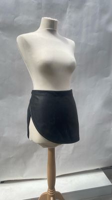 mannequin torso with black skirt on a wooden stand