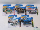 four hot wheels cars that are on the table