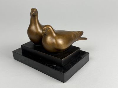 bronze sculpture of two birds on a black marble base