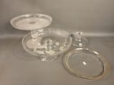 two plates and a glass cake stand on a table