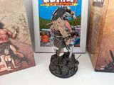 two books and a figurine of a warrior on a table