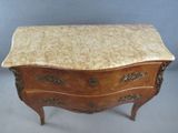 a marble top chest of drawers with a marble top