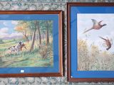 two framed pictures of birds on the wall of a room
