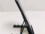 a black tablet on a stand on a white surface
