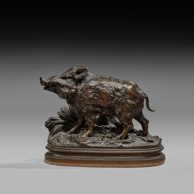 a bronze statue of a boar and a boar on a pedestal