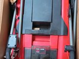 a red and black box with a red and black tool in it