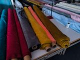 a lot of different colors of fabric on a table
