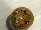 a close up of a wine bottle with a clock on it