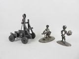 three metal figurines of a man with a catapult, a man with a gun, and a man with a catapult