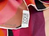 a close up of a colorful scarf with a tag on it