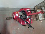 a small red machine that is sitting on the floor